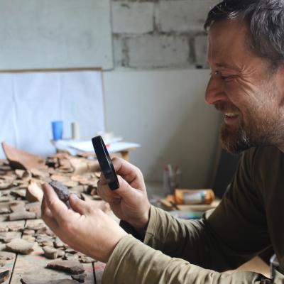 An archaeologist closely examines an artefact during one of our Archaeology opportunities abroad in Peru.